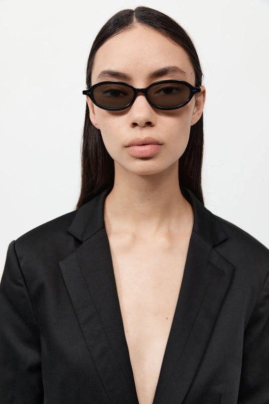 St. Agni - 90s Slim Oval Sunglasses in Black